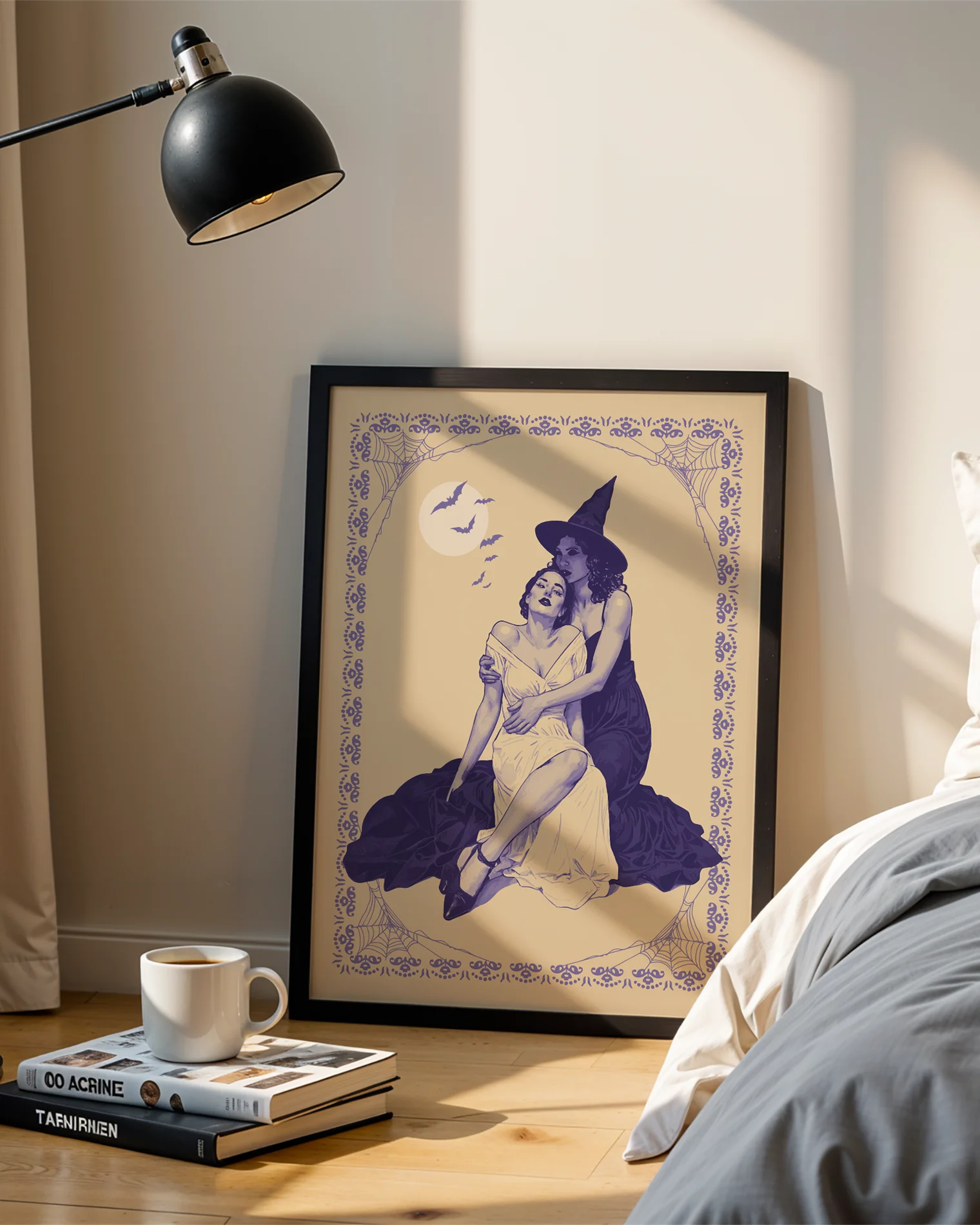 A poster with a witch tenderly holding her lover, surrounded by a spiderweb-infused frame and a large white full moon with flying bats in the background.