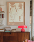 A print with an illustrated couple holding hands, with additional text about WLW - women who love women.