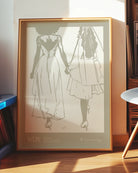 A print with an illustrated couple holding hands, with additional text about WLW - women who love women.