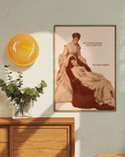 A framed poster featuring two sapphic women from the Victorian era in a conversation: 'Am I the first woman you've slept with?' 'You mean tonight?'.