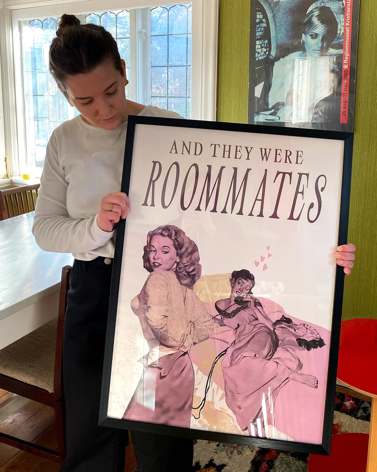 A photo of Amelia and a print from Queerwall.