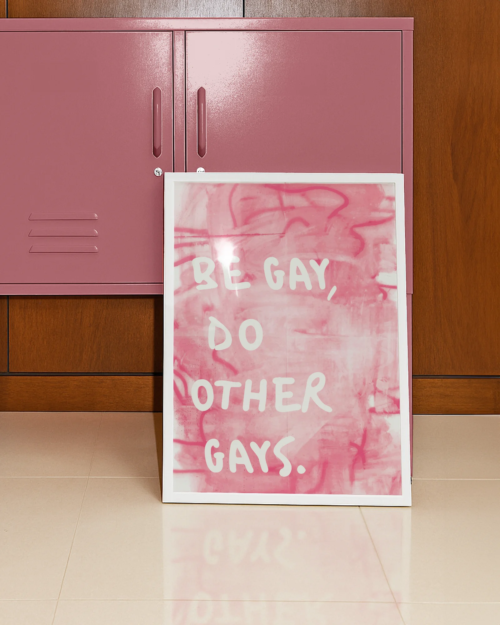 A framed poster with the text 'BE GAY, DO OTHER GAYS.', against a pink, abstract background.