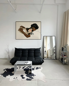 A framed, horizontal print with two lesbian women in a warm, romantic embrace.