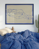 The poster shows two naked women in line art, lying down horizontally, holding each other.