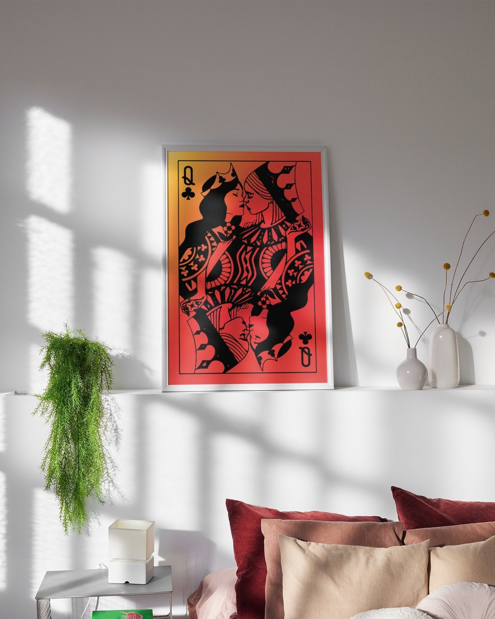 A poster with a sapphic couple kissing, card deck style. Two queens. Red background.