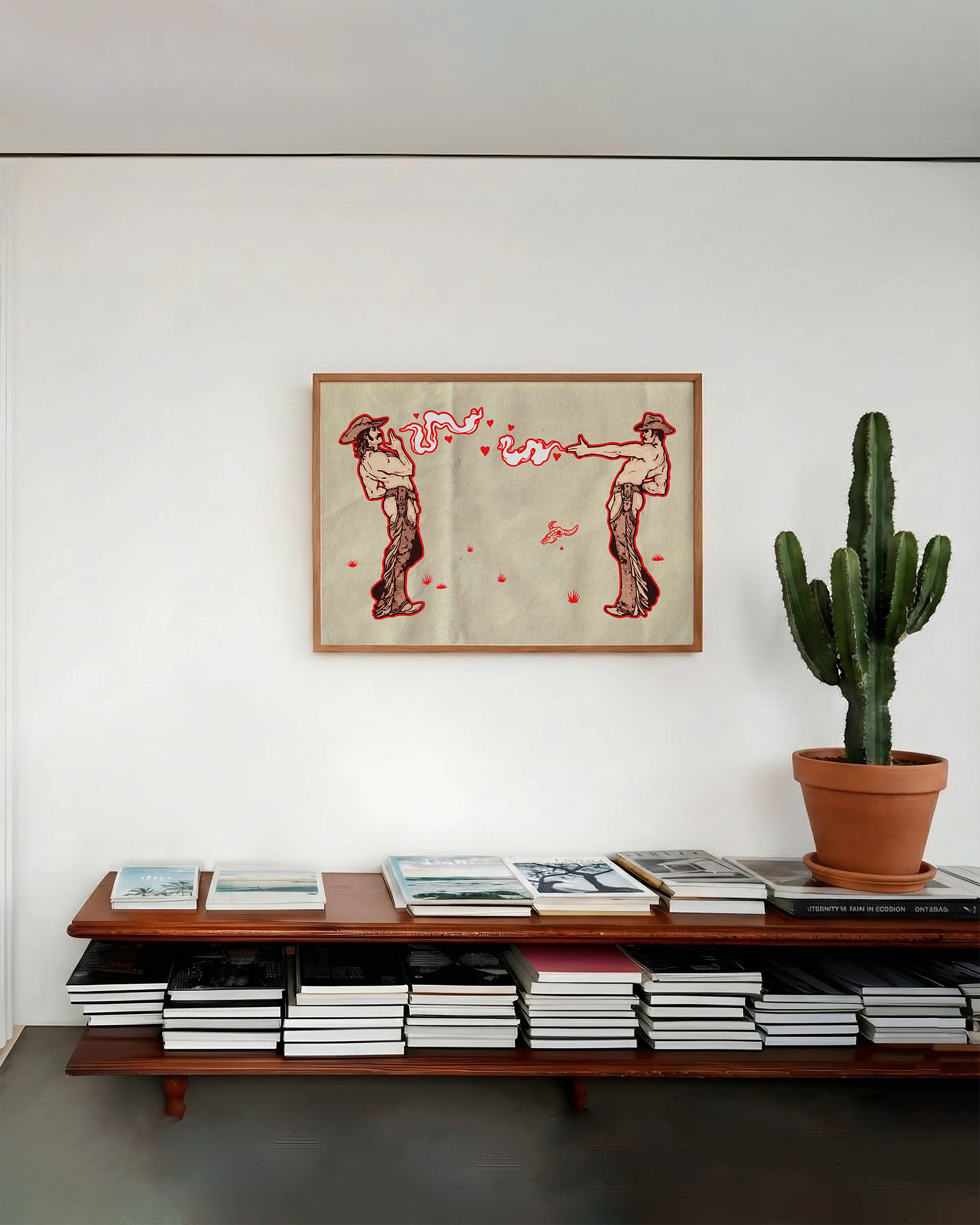 A framed poster with two gay cowboys.