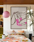 A poster with two naked cowgirls in pink boots.