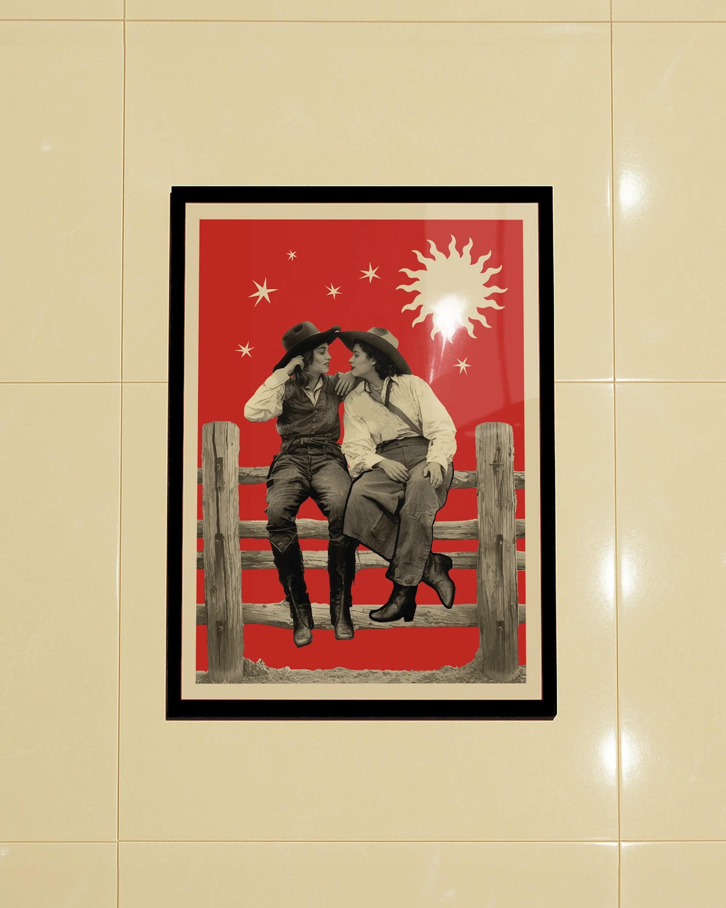 A framed poster with two lesbian cowgirls, sitting on a wooden fence, talking and flirting.