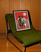 A framed poster with two lesbian cowgirls, sitting on a wooden fence, talking and flirting.
