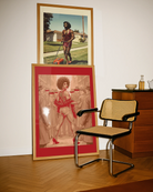 A framed poster featuring a fabulous drag queen standing in the middle of a crowd where every other face is blurred and anonymous. She’s the star — the rest is just background noise.