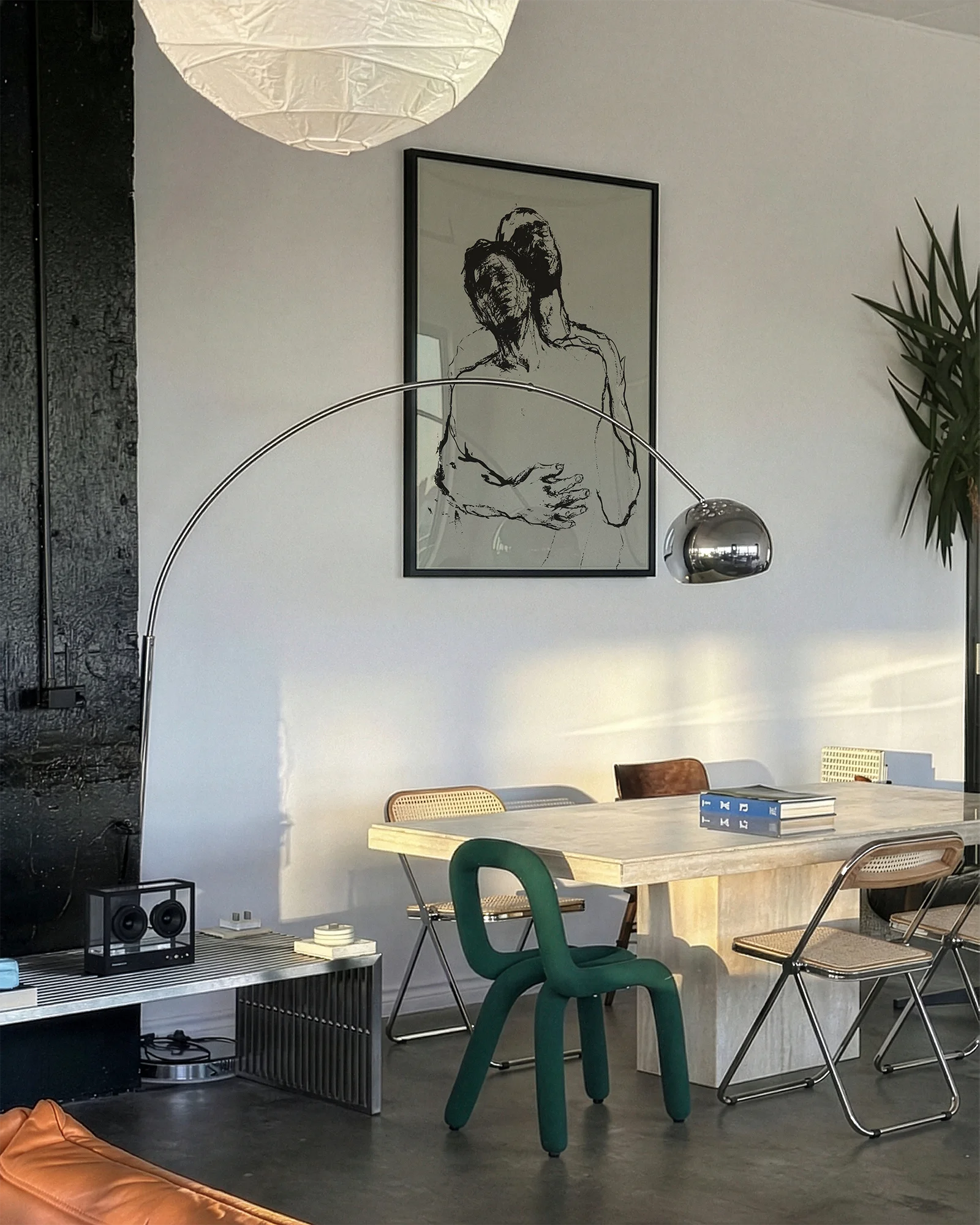 A framed poster with two, sketched gay men embracing in a dramatic pose.