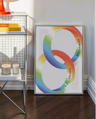 A print with two illustrated, shiny engagement rings in smooth pride colours with the engraved text 'Forever yours'.
