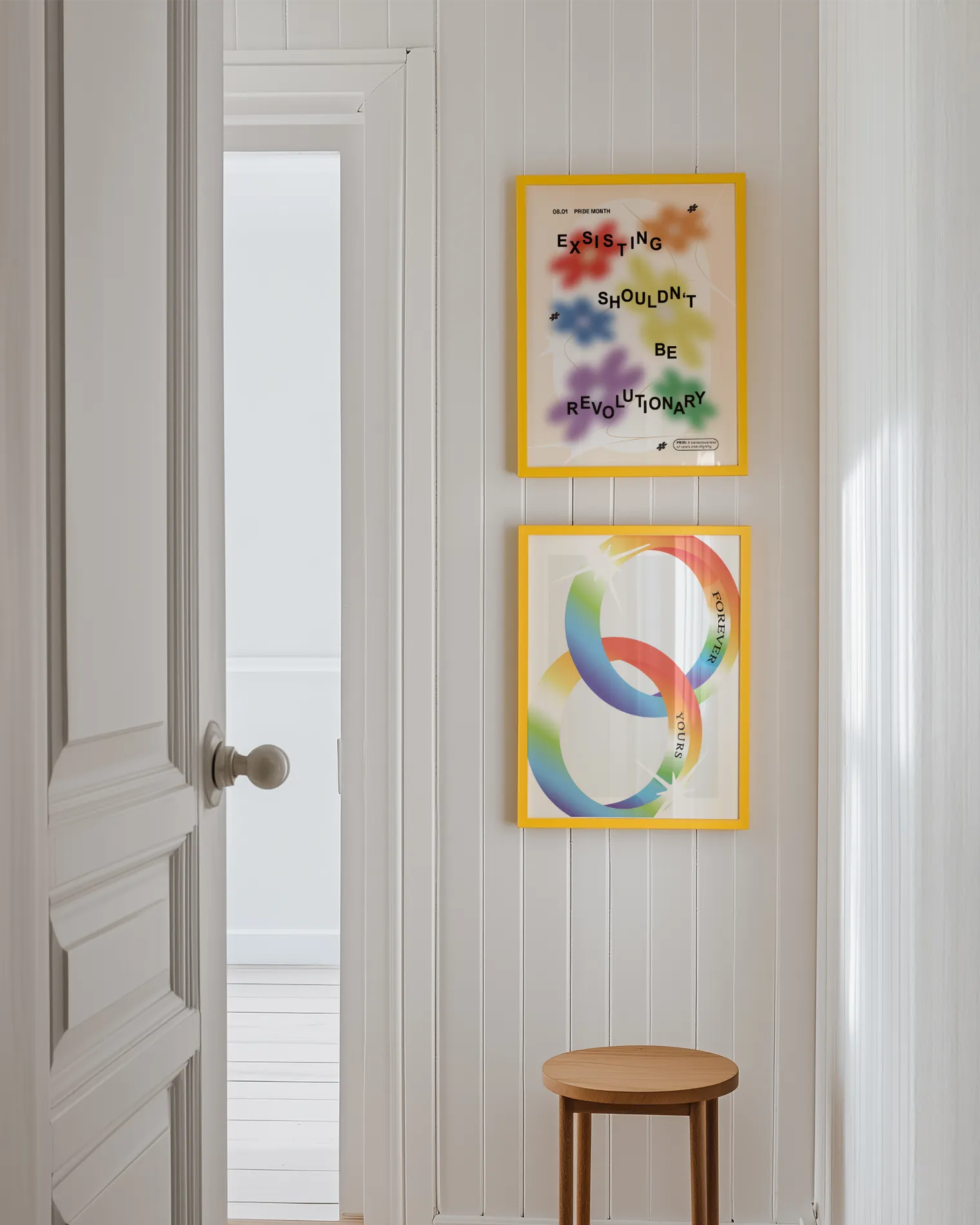 A gallery wall with two pride themed prints.