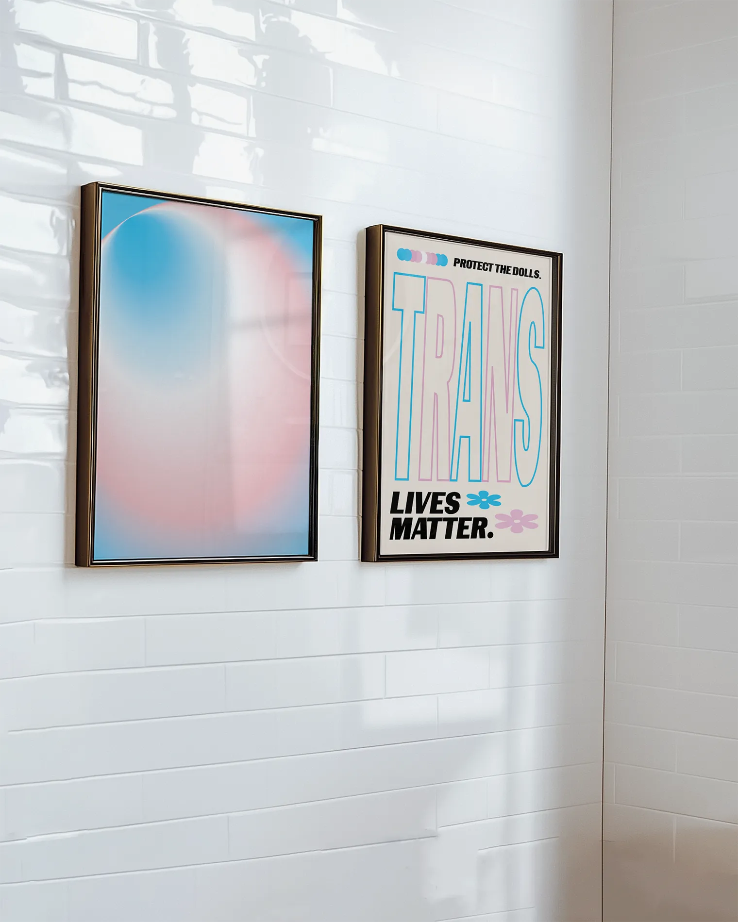 A gallery wall with two transpride themed prints.
