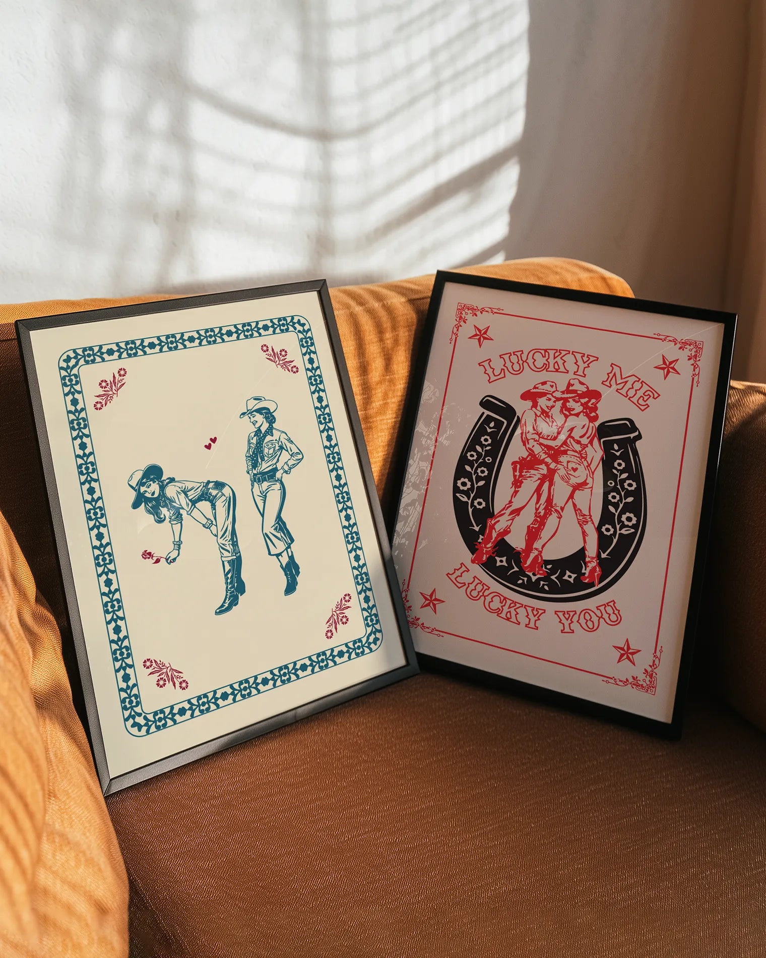 A gallery wall with two sapphic wild western themed prints.