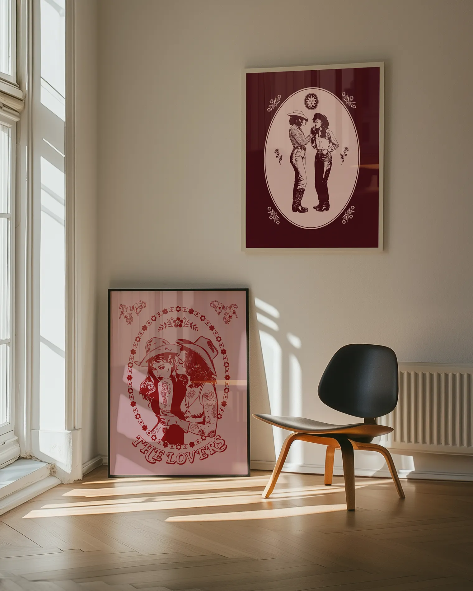 A gallery wall with two sapphic wild western themed prints.