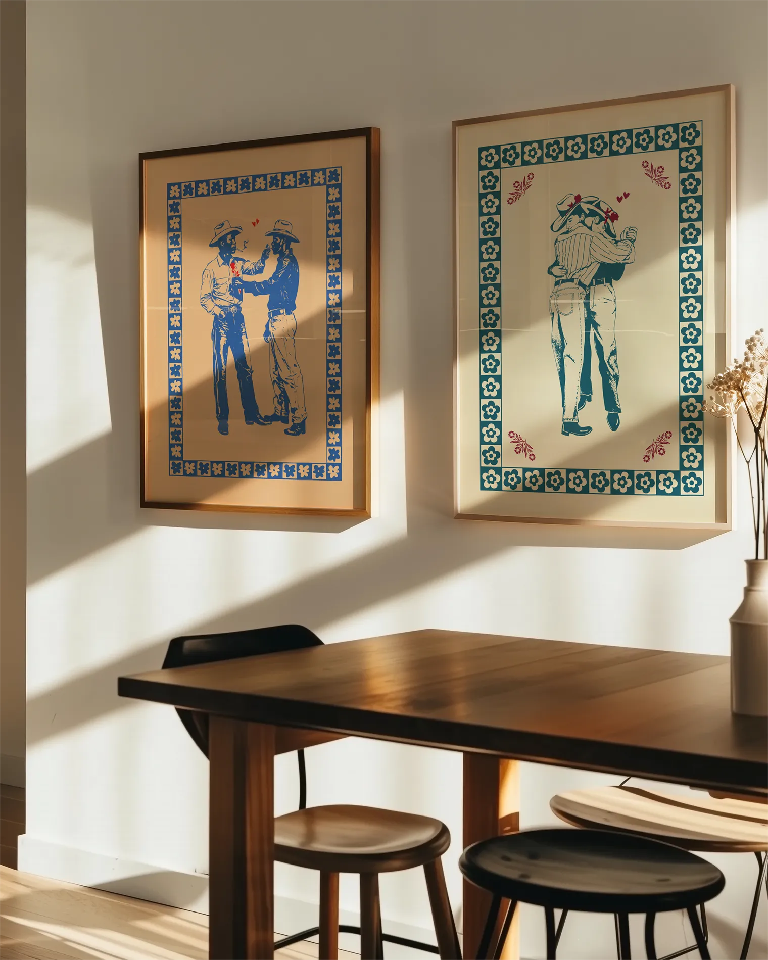 A gallery wall with two queer wild western themed prints.
