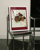 A framed print with two gentlemen in suits kissing on a couch, 1940's vintage style.