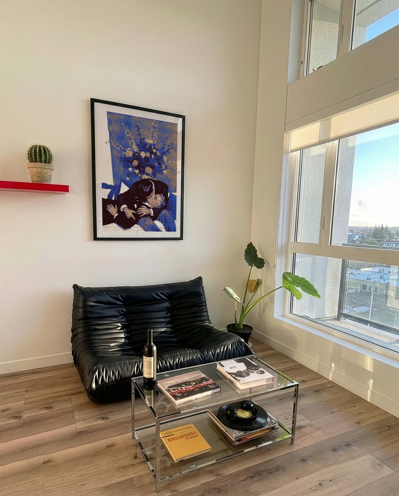 A framed poster with two, older men kissing on a couch.