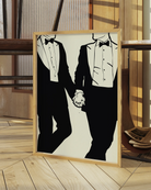 A print with an illustrated male couple in suits, hand in hand.