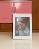 A framed print showing a hand bathed in sunlight, with a ray of rainbow light across the ring and index fingers, with the texts:
“DIVINE PLEASURE – THE HOLY FINGERS” and “Blessed be the hands that love, and know exactly where to go.”