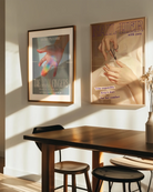 A framed print showing a hand bathed in sunlight, with a ray of rainbow light across the ring and index fingers, with the texts:
“DIVINE PLEASURE – THE HOLY FINGERS” and “Blessed be the hands that love, and know exactly where to go.”