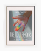 A framed print showing a hand bathed in sunlight, with a ray of rainbow light across the ring and index fingers, with the texts:
“DIVINE PLEASURE – THE HOLY FINGERS” and “Blessed be the hands that love, and know exactly where to go.”