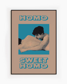 A framed poster featuring two naked men lying closely together in a soft and romantic pose, with the text: “HOMO SWEET HOMO.”