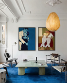 A framed print with two gay men hugging tightly, vintage 1940's style.