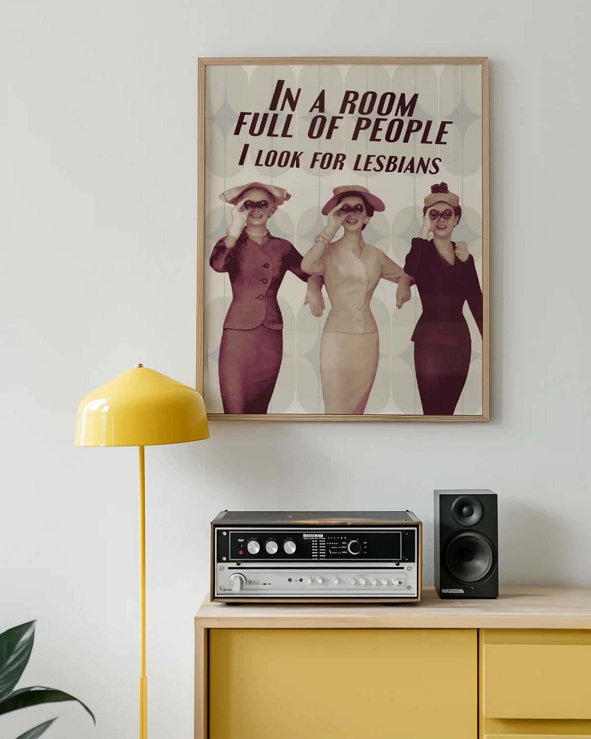 A poster with three ladies in vintage style holding binoculars with the text 'In a room full of people, I look for lesbians'.