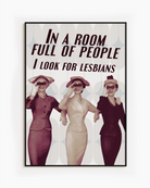 A poster with three ladies in vintage style holding binoculars with the text 'In a room full of people, I look for lesbians'.