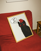 A framed print with a black, punk cat with the text 'It's punk to be gay'.