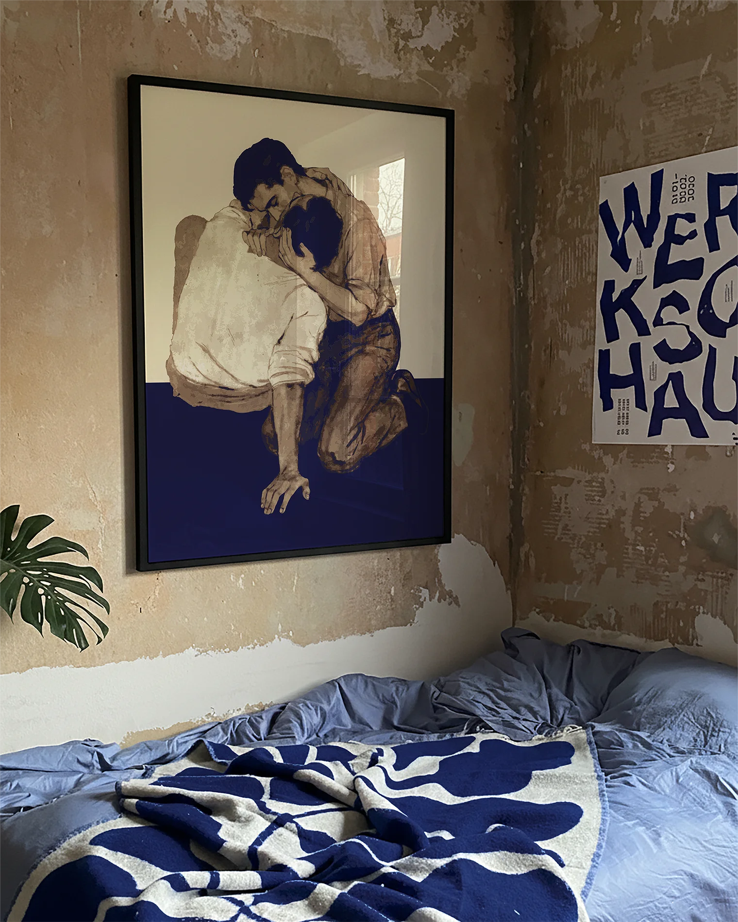 A poster with two men kissing on the floor.