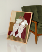 A framed poster with two gay men kissing each other on the cheek, abstract style.