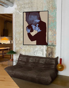 A framed poster with two gay men kissing, pop art style.