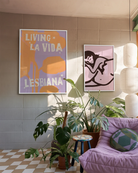 A poster with the text 'LIVING LA VIDA LESBIANA' against an abstract background.