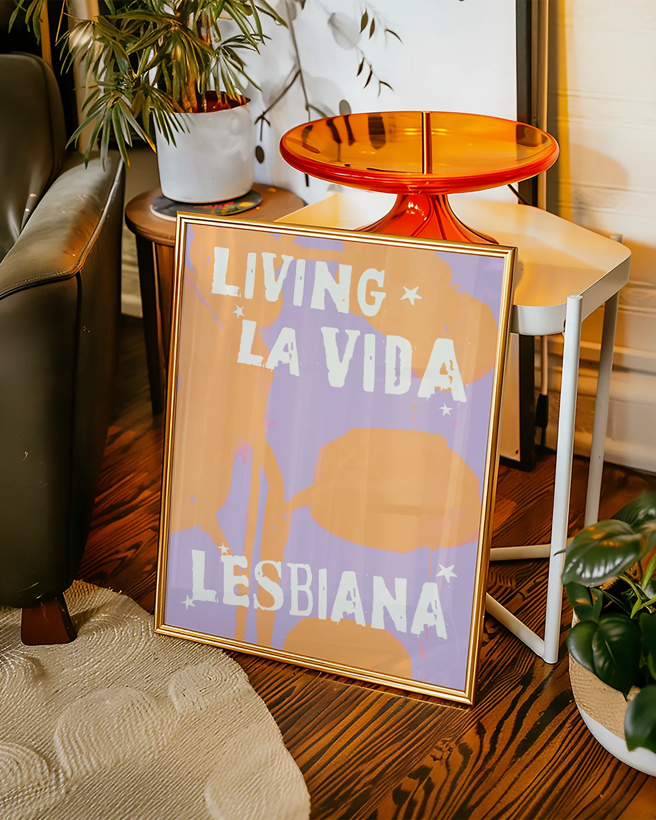 A poster with the text 'LIVING LA VIDA LESBIANA' against an abstract background.