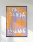 A poster with the text 'LIVING LA VIDA LESBIANA' against an abstract background.