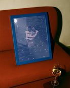 A poster with two gay men hugging each other in a dark blue lake.