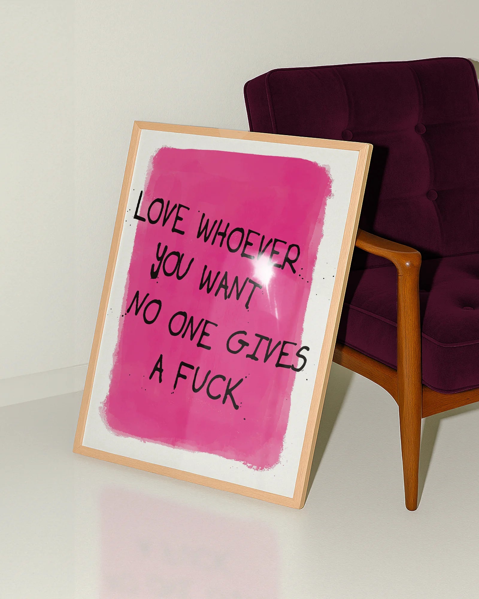 A poster with a text 'Love whoever you want no one gives a fuck', against a pink background.