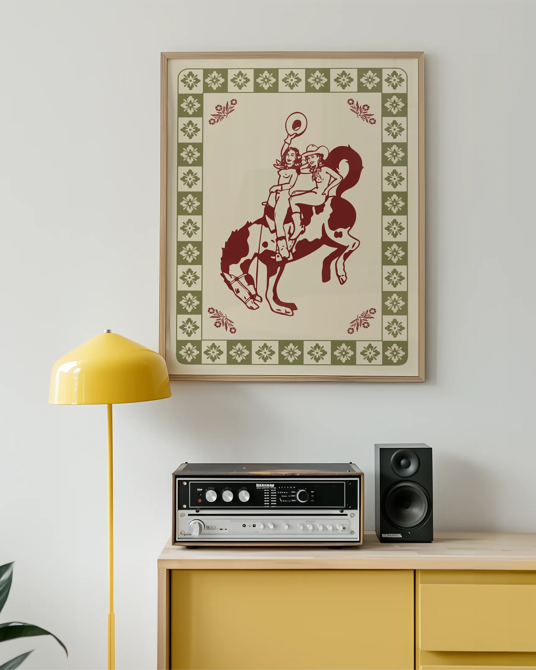 A framed poster with two, naked cowgirls riding a horse.