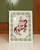 A framed poster with two, naked cowgirls riding a horse.