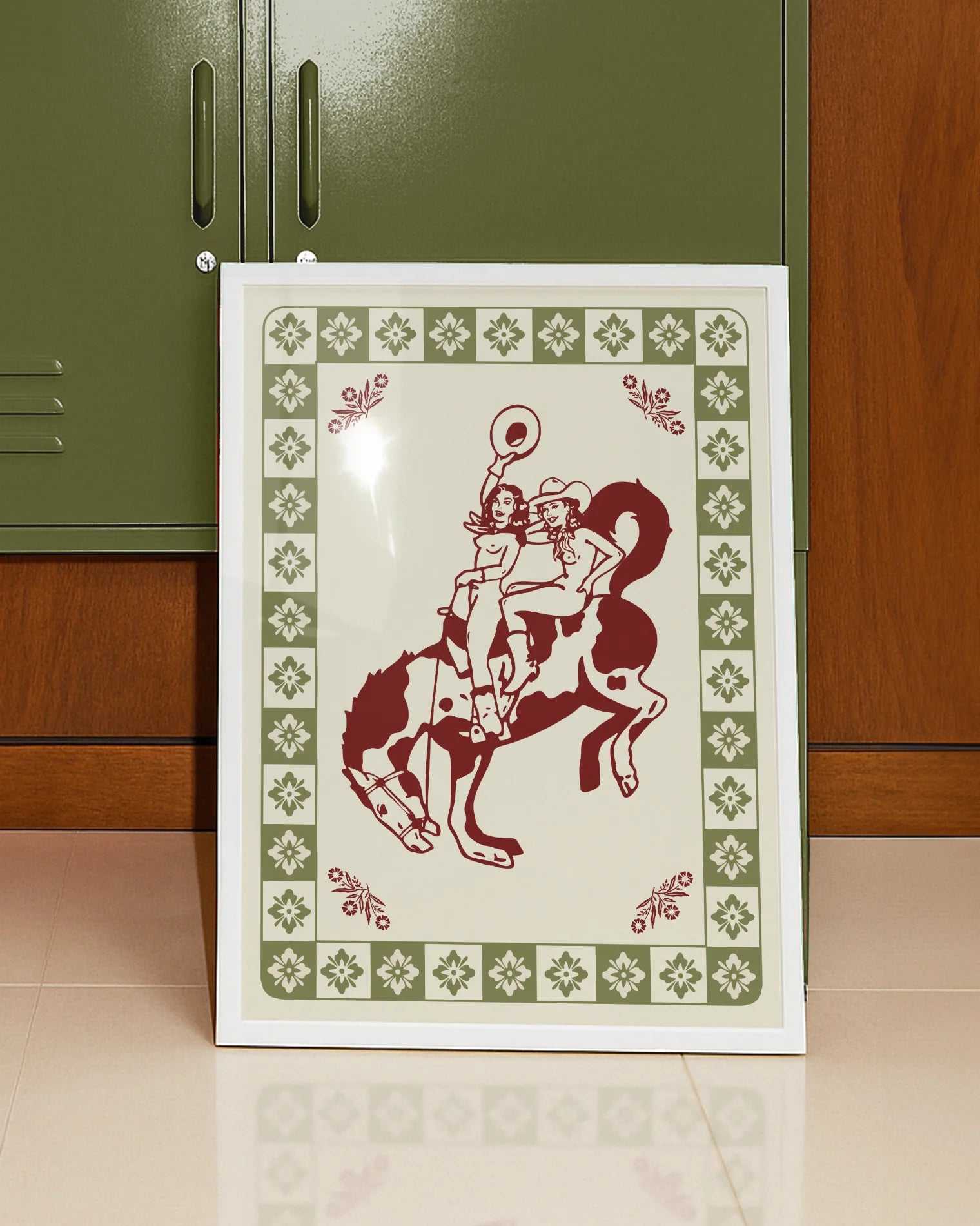 A framed poster with two, naked cowgirls riding a horse.