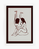 A framed print with two naked girls, hugging tight on the floor.
