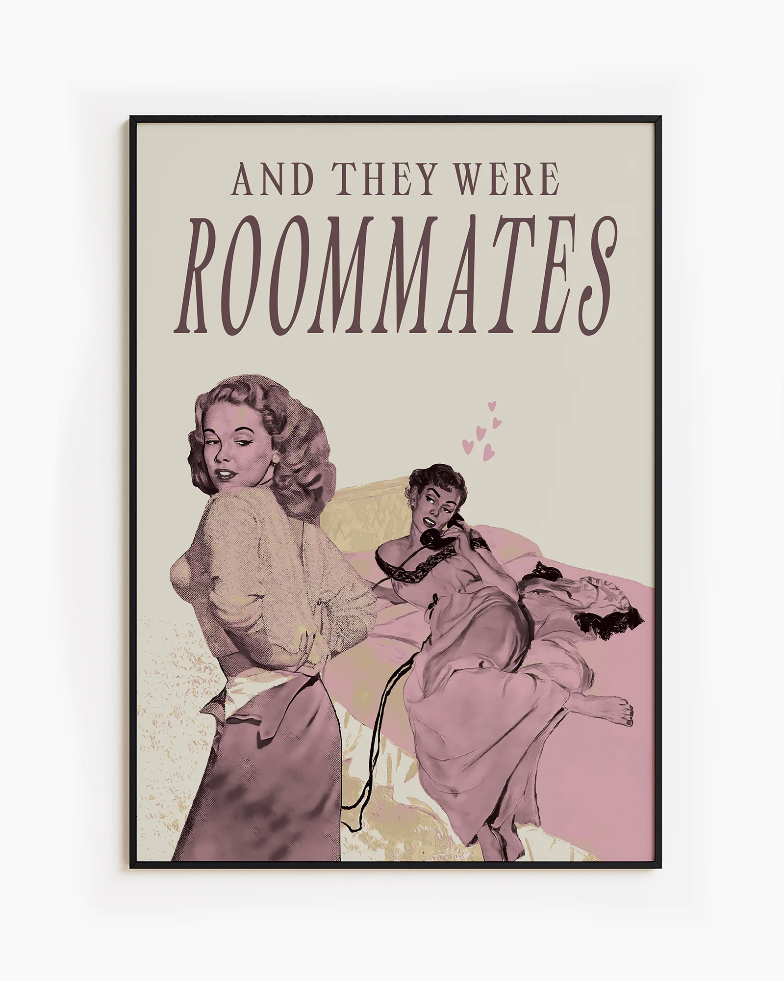 A framed poster depicting a woman lying in bed, and another woman undressing to join her — with the text “AND THEY WERE ROOMMATES.”