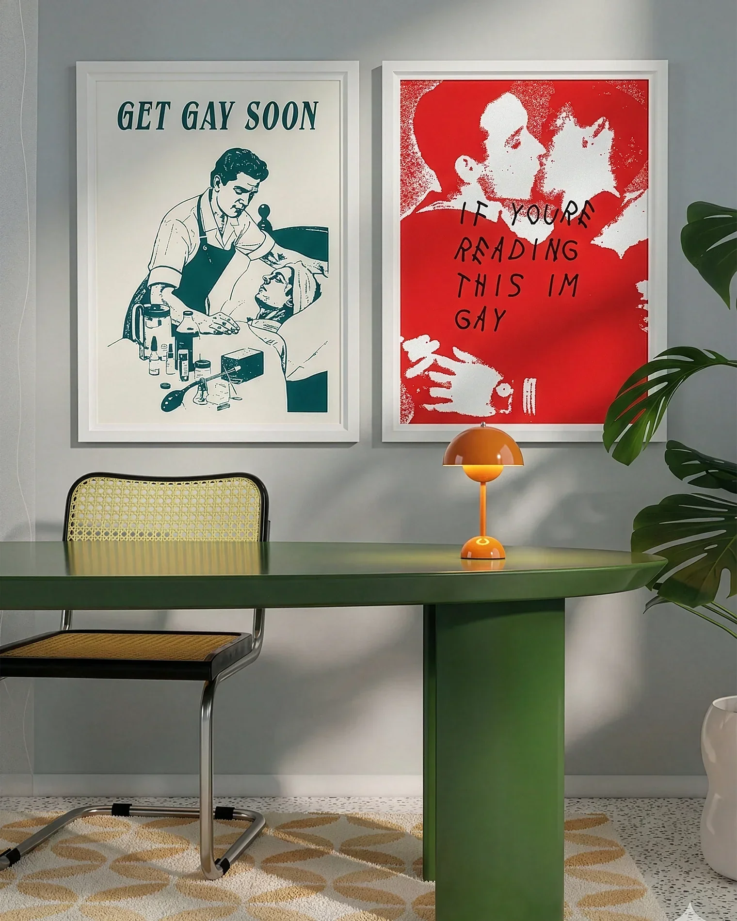 A gallery wall with several framed, queer posters in a living room.