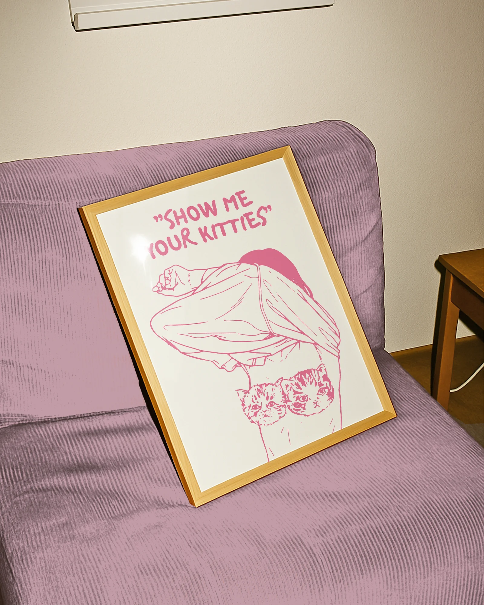 A poster of a woman removing her shirt with the text "SHOW ME YOUR KITTIES".