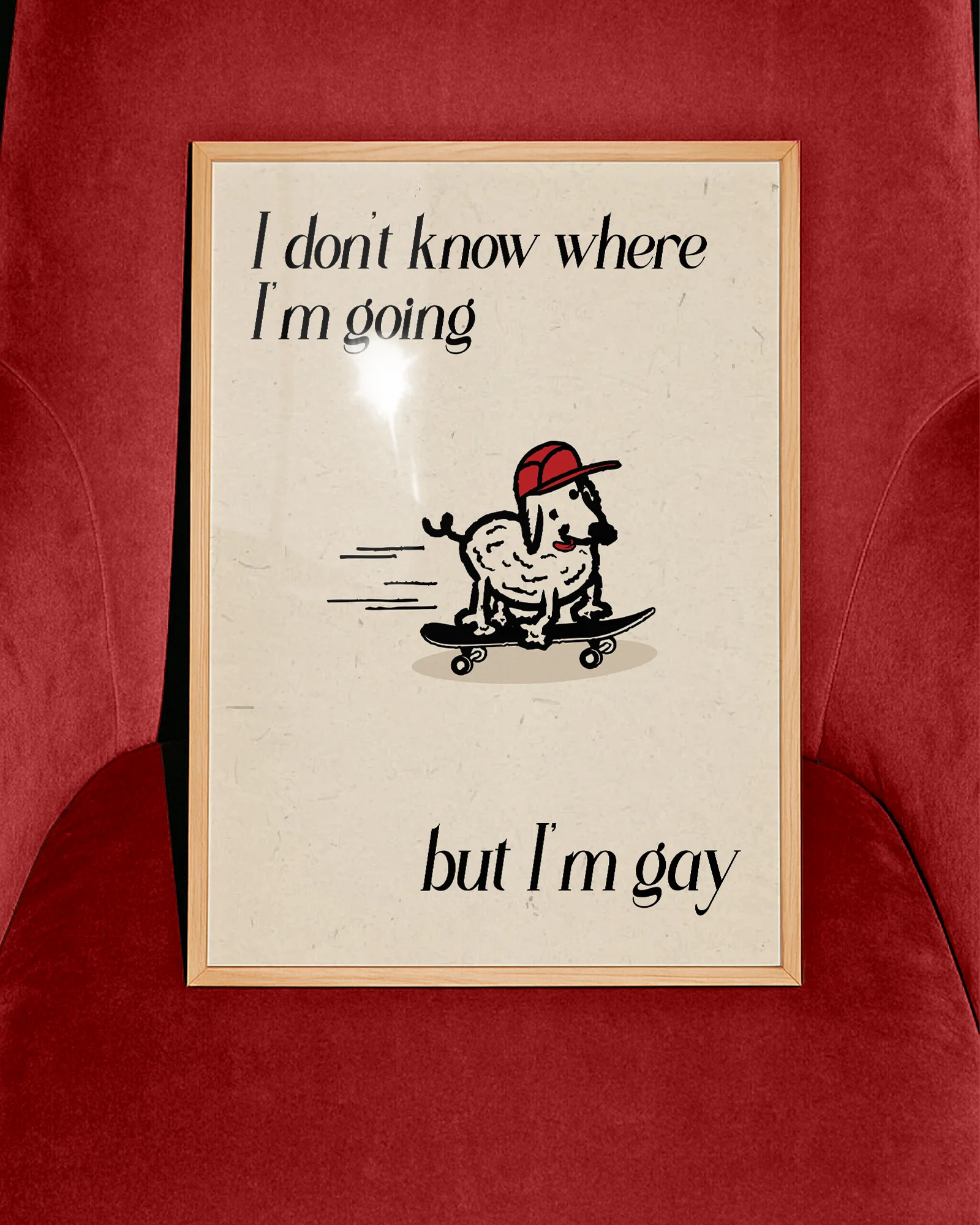 A framed poster with a cute, curly dog on a skateboard with the text 'I don't know where I'm going but I'm gay.