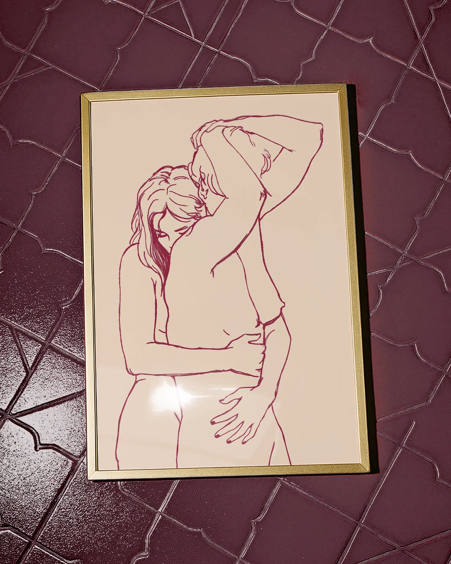 A framed print with two lesbian, naked girls hugging.
