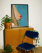 A framed poster showing female breasts coevered with a red star, abstract and grainy style.